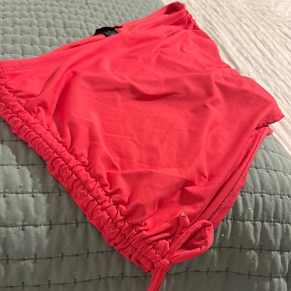 Vibrant Coral Swim skirt with attached bikini underneath. Shows off that tan!
